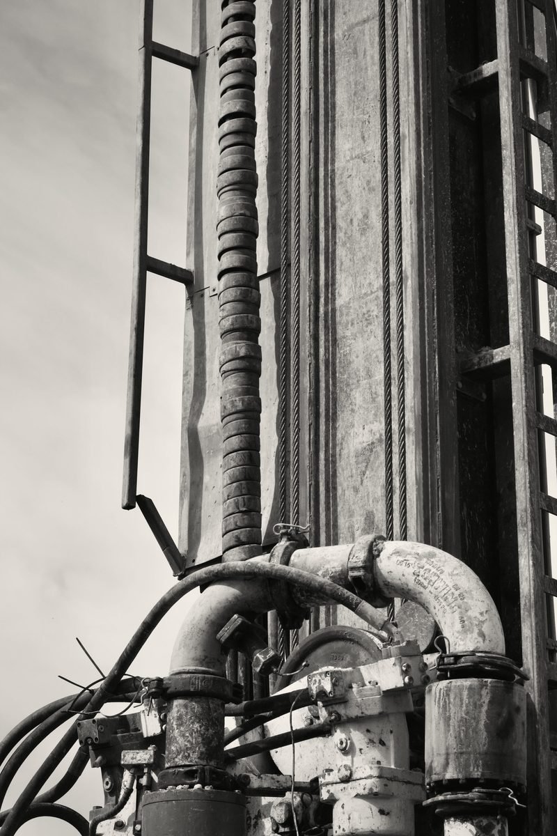 Black and white close-up of a mast with hose, standpipe and ladder